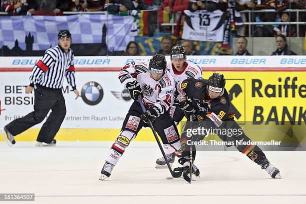 Moritz Mueller of Germany fights for the puck with Thomas Koch of Austria during the Olympic Icehockey Qualifier match between Germany and Austria on...