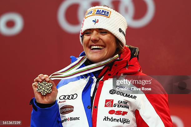 Marion Rolland of France celebrates at the medal ceremony with her gold medal after winning the Women's Downhill during the Alpine FIS Ski World...