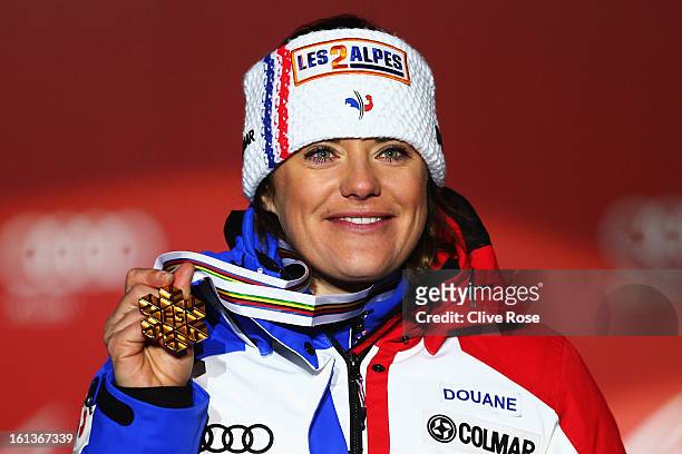 Marion Rolland of France celebrates at the medal ceremony with her gold medal after winning the Women's Downhill during the Alpine FIS Ski World...