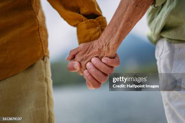 close up of senior couple holding hands. - old man close up stock-fotos und bilder