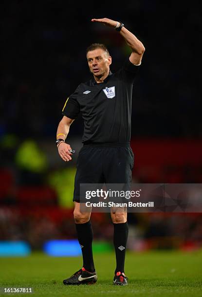 Referee Mark Halsey gestures during the Barclays Premier League match between Manchester United and Everton at Old Trafford on February 10, 2013 in...