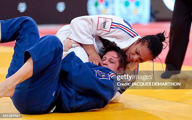 France's Lucie Decosse competes against France's Marie Pasquet on February 10, 2013 for the bronze medal of the Women -70kg category during the Paris...