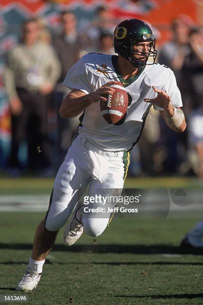 Quarterback Joey Harrington of the Oregon Ducks looks to pass the ball against the Colorado Buffaloes during the Tostitos Fiesta Bowl at Sun Devil...