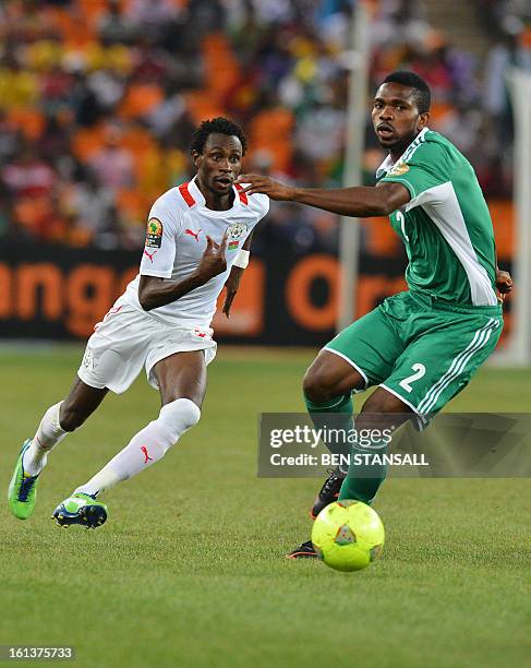 Burkina Faso's midfielder Jonathan Pitroipa and Nigeria's defender Joseph Yobo fight for the ball during the 2013 African Cup of Nations final...