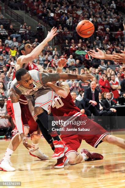 Deshaun Thomas of the Ohio State Buckeyes battles for control of a loose ball with Will Sheehey of the Indiana Hoosiers and Cody Zeller of the...