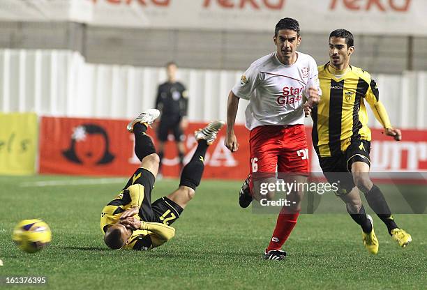 Beitar Jerusalem player Ofir Kriaf fights for the ball with Bnei Sakhnin player Adir Tubul at the Teddy Kollek Stadium in Jerusalem on February 10,...