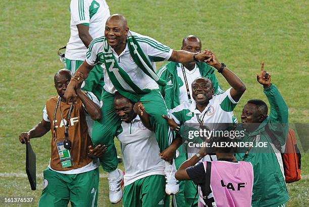 Nigeria's head coach Stephen Keshi is carried by staff members as they celebrate winning the 2013 African Cup of Nations final against Burkina Faso...