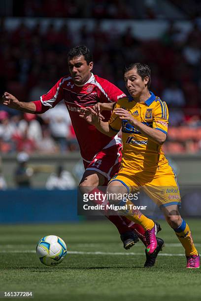 Edgar Duenas of Toluca fights for the ball with Jose Francisco Torres of Tigres during a match between Toluca and Tigres as part of the Clausura...