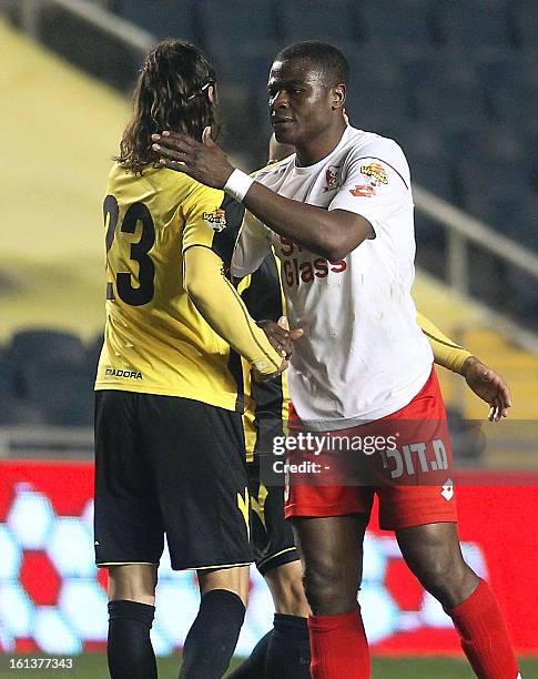 Beitar Jerusalem players and Bnei Sakhnin players congratulate each other after their match at the Teddy Kollek Stadium in Jerusalem on February 10,...