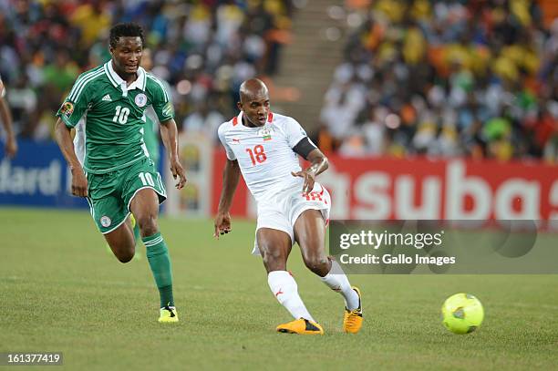 Charles Kabore of Burkina Faso and John Obi Mikel of Nigeria in action during the 2013 Orange African Cup of Nations Final match between Nigeria and...