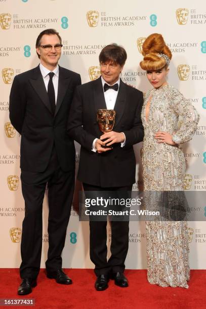 Thomas Newman, winner of Original Film Music for 'Skyfall', poses in the press room with presenters David Morrissey and Paloma Faith at the EE...