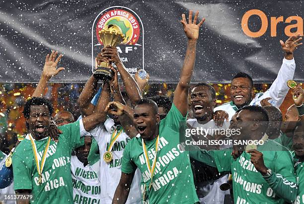 Nigeria's national football team players hold the trophy as they celebrate winning the 2013 African Cup of Nations final against Burkina Faso on...