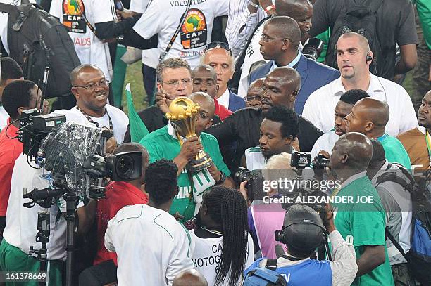Nigeria's head coach Stephen Keshi kisses the trophy as he celebrates winning the 2013 African Cup of Nations final against Burkina Faso on February...