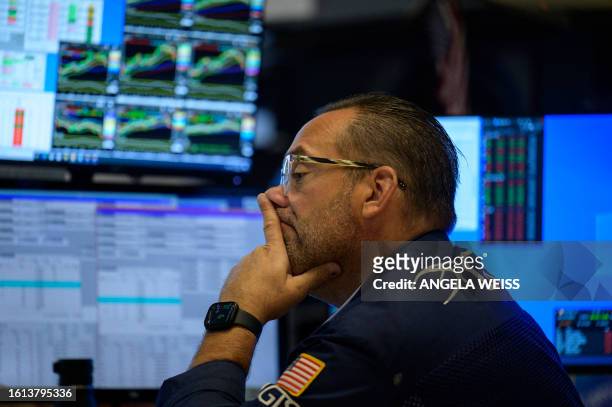 Trader works on the floor of the New York Stock Exchange during opening bell in New York City on August 21, 2023. European and US stocks rebounded on...