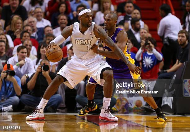 Kobe Bryant of the Los Angeles Lakers guards LeBron James of the Miami Heat during a game at American Airlines Arena on February 10, 2013 in Miami,...
