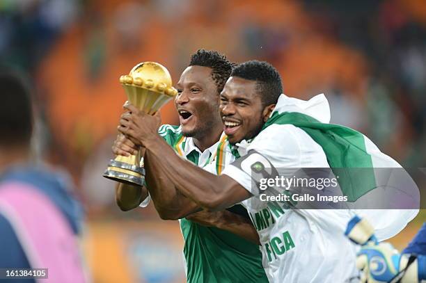 John Obi Mikel celebrates holding the trophy during the 2013 Orange African Cup of Nations Final match between Nigeria and Burkina Faso from the...