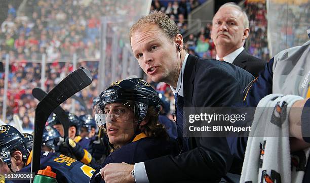 Assistant coach Kevyn Adams of the Buffalo Sabres talks to Tyler Ennis during their game against the Montreal Canadiens on February 7, 2013 at the...