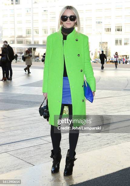 Blair Eadie is seen wearing a coat by Acme, Furlane sweater, Forever 21 skirt, Givenchy shoes and Karen Walker glasses at Lincoln Center Plaza on...