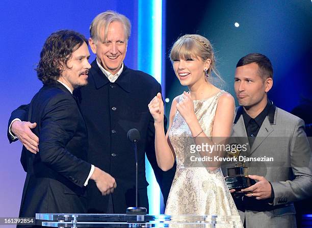 Kaskade looks on as songerwriter John Paul White, singers T Bone Burnett and Taylor Swift accept the Best Song Written For Visual Media Award for...