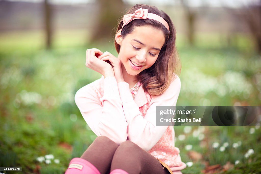 Girl Sitting Down in Snowdrop Woodland