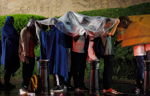 Migrants who had waited in line throughout the night outside of Federal Plaza for an U.S. Immigration and Customs Enforcement check-in appointment...