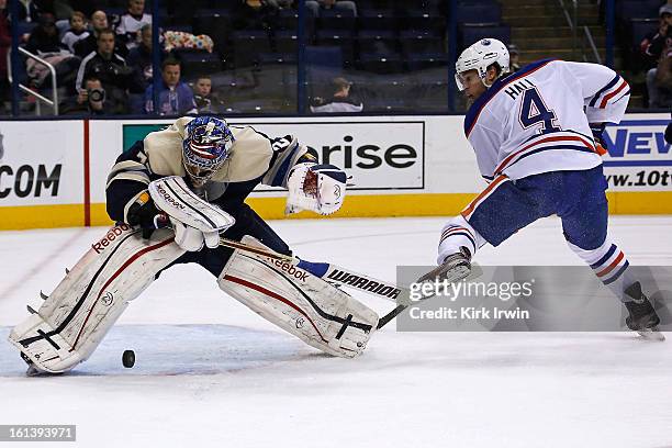 Sergei Bobrovsky of the Columbus Blue Jackets makes a save on Taylor Hall of the Edmonton Oilers but is unable to control the rebound during the...