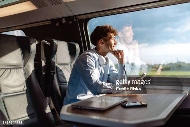 business-casual man travels by train - working on laptop in train top view imagens e fotografias de stock