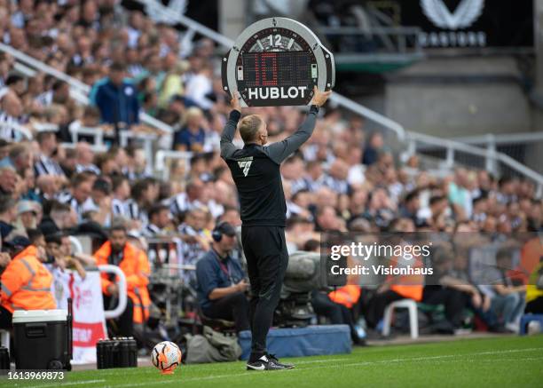 The fourth official holds up ten minutes of added time during the Premier League match between Newcastle United and Aston Villa at St. James Park on...