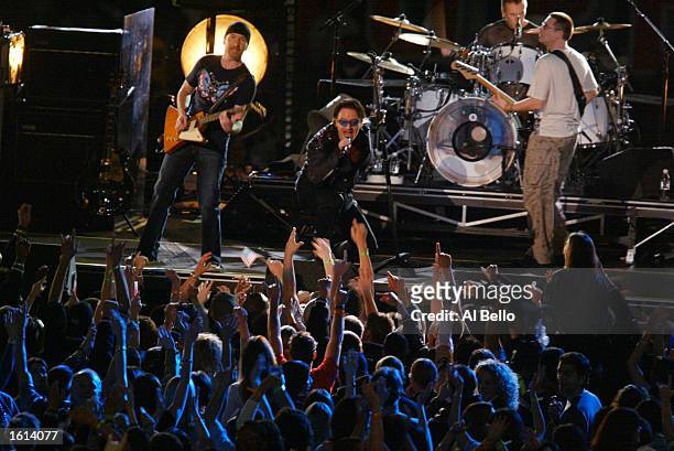 Bono and U2 performs at halftime of Super Bowl XXXVI between the New England Patriots and the St. Louis Rams at the Superdome in New Orleans,...