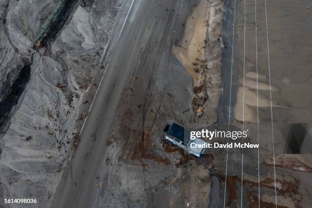 In an aerial view, a Jeep remains stuck in mud off a road that was hit by a flash flood in the aftermath of Tropical Storm Hilary on August 21, 2023...