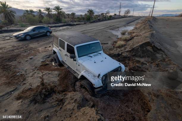 Jeep remains stuck in mud off a road that was hit by a flash flood in the aftermath of Tropical Storm Hilary on August 21, 2023 near Indio...