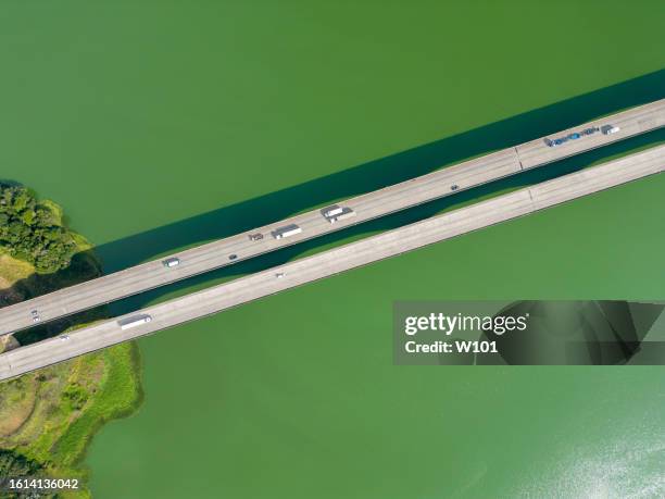 aerial view of a road with vehicles over the river - green bridge over trees stock pictures, royalty-free photos & images