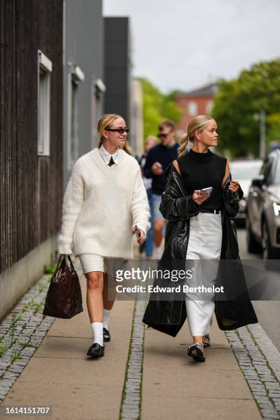 Guest wears black sunglasses, a white shirt, a black tie, a white latte oversized fluffy pullover, white denim shorts, a dark brown shiny leather...