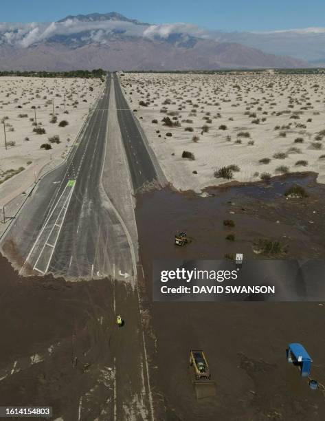 An aerial image shows no traffic on Interstate 10 due to flooding and mud crossing the highway following heavy rains from Tropical Storm Hilary, in...