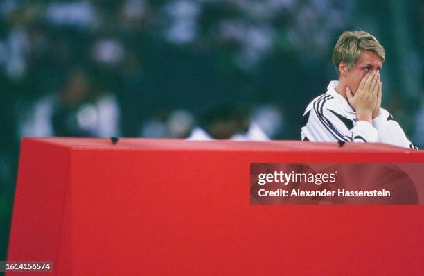 German athlete Astrid Kumbernuss in tears with her hands over her mouth after winning gold in the women's shot put event of the 1996 Summer Olympics,...