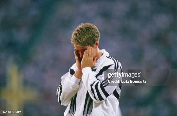 German athlete Astrid Kumbernuss with her head in her hands after winning gold in the women's shot put event of the 1996 Summer Olympics, held at the...