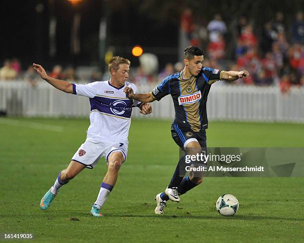 Leo Fernandes of the Philadelphia Union runs upfield against defender Bryan Burke of Orlando City February 9, 2013 in the first round of the Disney...