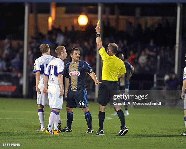 Referee signals a yellow card as the Philadelphia Union play against Orlando City February 9, 2013 in the first round of the Disney Pro Soccer...