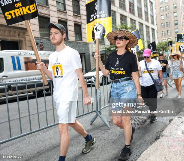 Roman Walker Zelman and Debra Messing are seen at the SAG-AFTRA picket line in Downtown, Manhattan on August 21, 2023 in New York City.