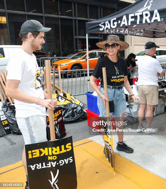 Roman Walker Zelman and Debra Messing are seen at the SAG-AFTRA picket line in Downtown, Manhattan on August 21, 2023 in New York City.