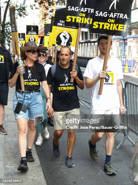 Debra Messing, Peter Jacobson and Roman Walker Zelman are seen at the SAG-AFTRA picket line in Downtown, Manhattan on August 21, 2023 in New York...