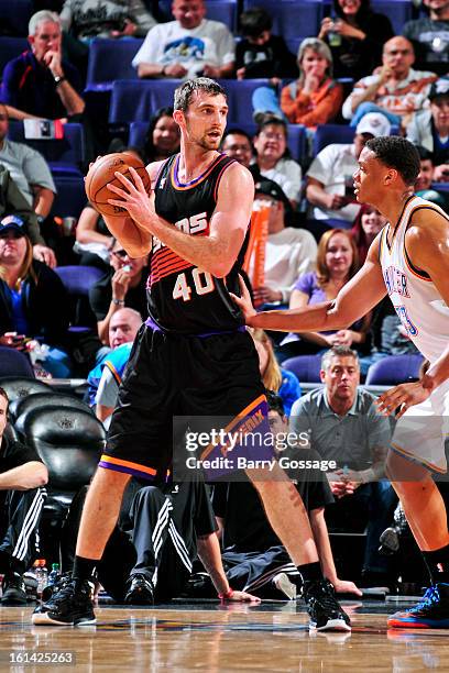 Luke Zeller of the Phoenix Suns controls the ball against Daniel Orton of the Oklahoma City Thunder on February 10, 2013 at U.S. Airways Center in...