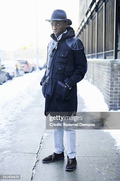 Roger Inniss, Casting Director, is seen outside the Y-3 show wearing Issey Miyaki coat, Bailey of Hollywood hat and Michael Bastian pants on February...