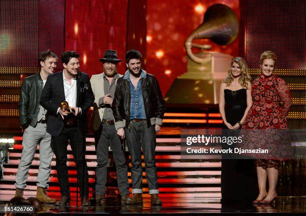 Musicians Ben Lovett, Marcus Mumford, Ted Dwane and Winston Marshall of Mumford & Sons accept Album of the Year award for "Babel" with presenter...