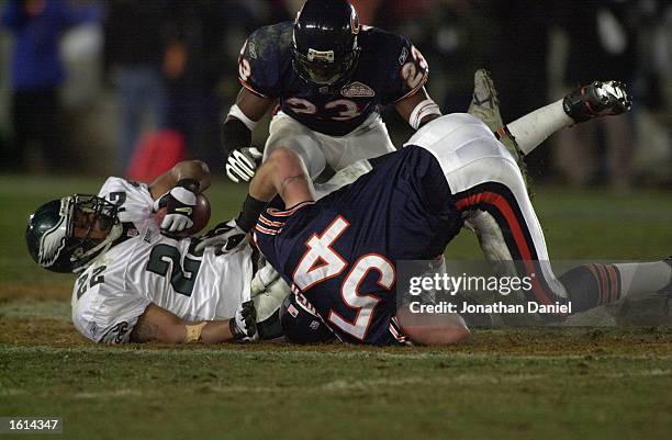 Duce Staley of the Philadelphia Eagles is crushed by Brian Urlacher and Jerry Azumah of the Chicago Bears during the NFC divisional playoff game at...