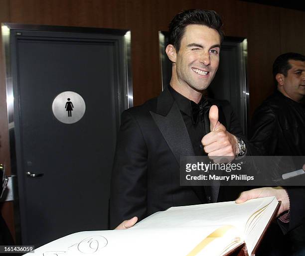 Singer Adam Levine of Maroon 5 poses with the GRAMMY Charities Signing Booth during the 55th Annual GRAMMY Awards at STAPLES Center on February 10,...
