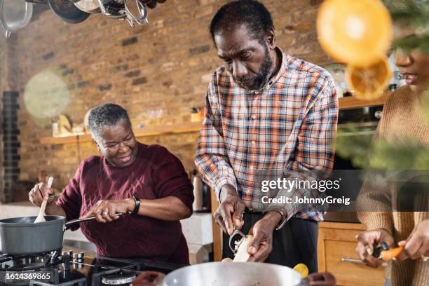 black family members peeling and cooking root vegetables - fruit stand stock pictures, royalty-free photos & images