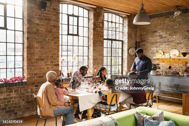 three-generation british family seated for christmas lunch - annual event stock pictures, royalty-free photos & images