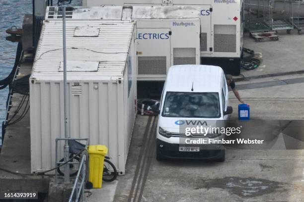 Van with the Offshore Water Management Ltd company logo displayed is seen on the pier by the Bibby Stockholm immigration barge, on August 14, 2023 in...