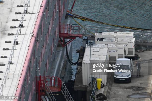 Van with the Offshore Water Management Ltd company logo displayed is seen on the pier by the Bibby Stockholm immigration barge, on August 14, 2023 in...